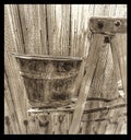 Bucket on ladder metal on metal wooden back ground